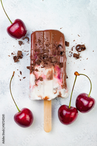 Black Forest chocolate fudge popsicles with roasted cherries and coconut cream. Vegan creamy ice pops, nicecream, fudgesicles photo