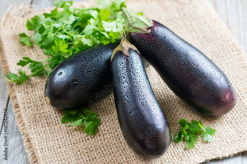 Fresh eggplant on wooden background