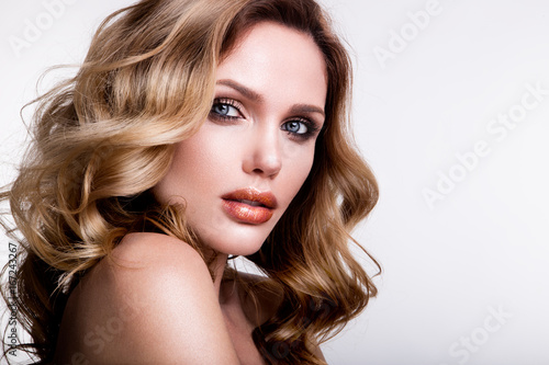 Beautiful young girl with orange lips and curly hair