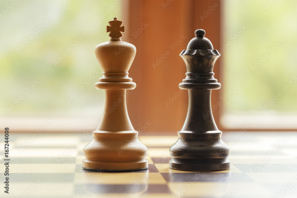 A checkerboard with black and white figures in a team A checkerboard with black and white figures in a team