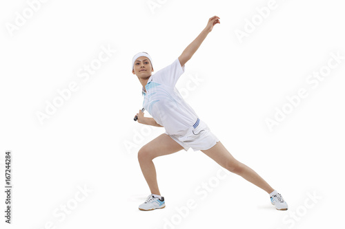 Fototapeta Naklejka Na Ścianę i Meble -  Young woman in sports wear playing badminton isolated over white background