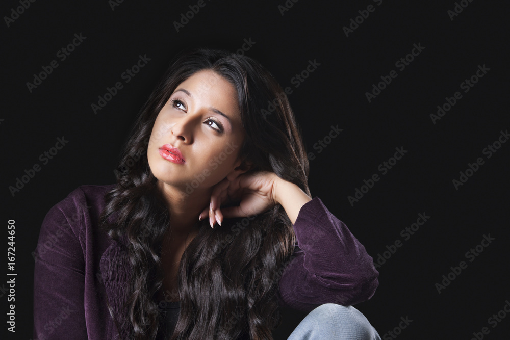 Fototapeta premium Young woman looking up