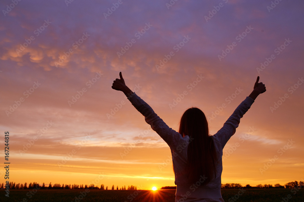 Silhouette of a girl enjoying sunset Silhouette of a girl enjoying sunset