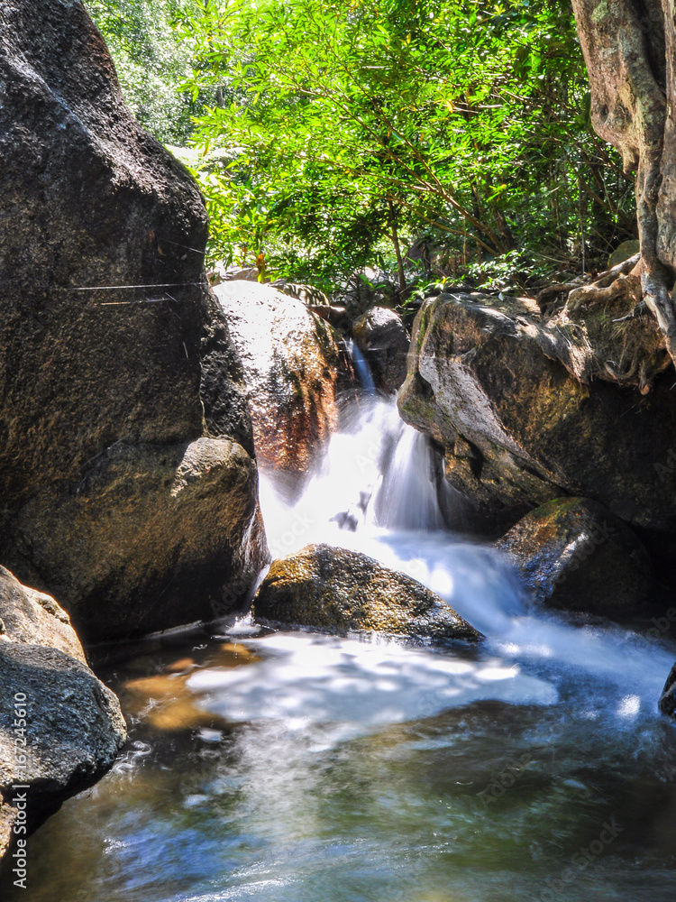 The soft stream is flowing through the rocks. The soft stream is flowing through the rocks.