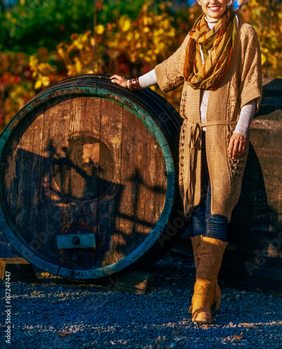 Closeup on woman standing in autumn vineyard