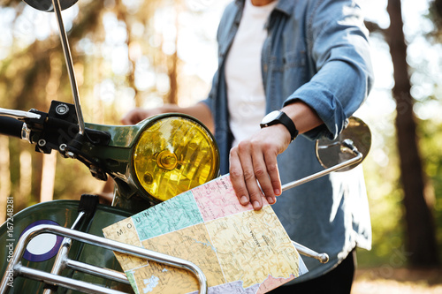 Cropped image of young man holding map