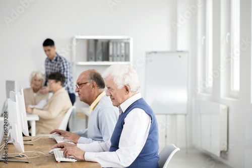 Elder men using computers