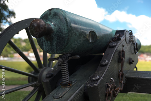 Very old artillery canon in a park photo