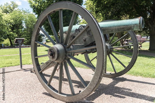 Very old artillery canon in a park photo