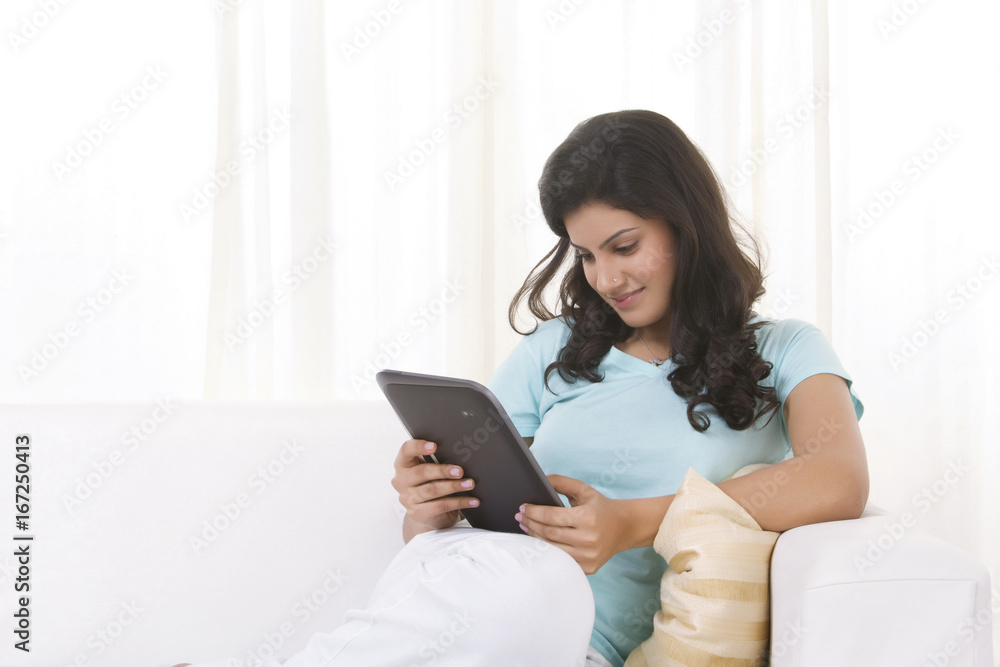 Woman reading an article on a digital tablet Woman reading an article on a digital tablet