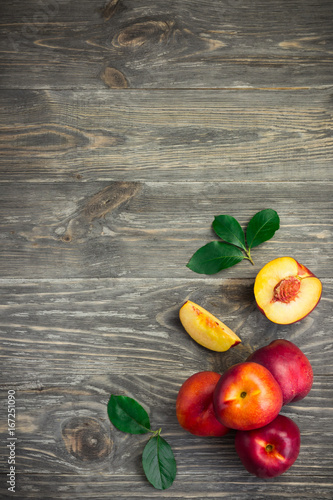 Delicious nectarines on rustic wooden background. Top view copy space.