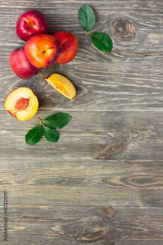 Ripe nectarines on a plate on old garden table. Top view copy space.