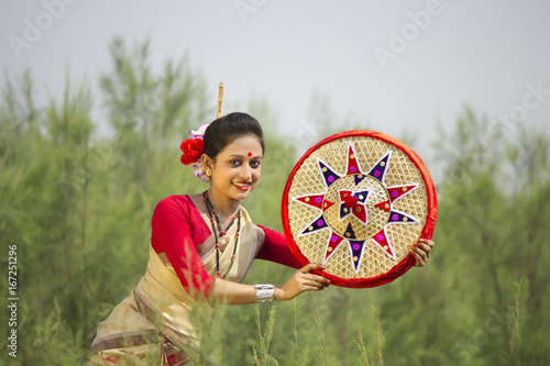 Bihu woman holding a jaapi  photo