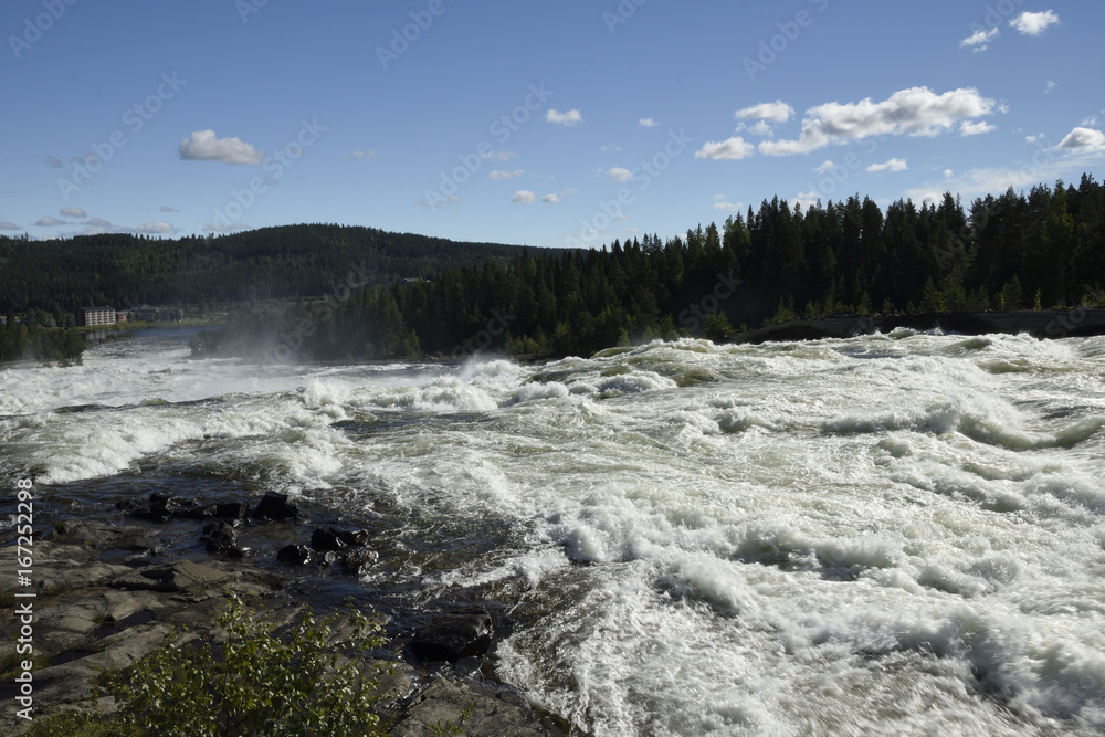 The rapid (Storforsen) in the river (Piteälven) with the hotel in background.