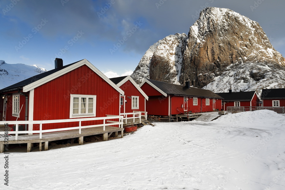 Tourist rorbuer-traditional fishing cottages-Festhaeltinden mount across the fjord. Hamnoy-Reine-Moskenesoya-Lofoten-Norway. 0243