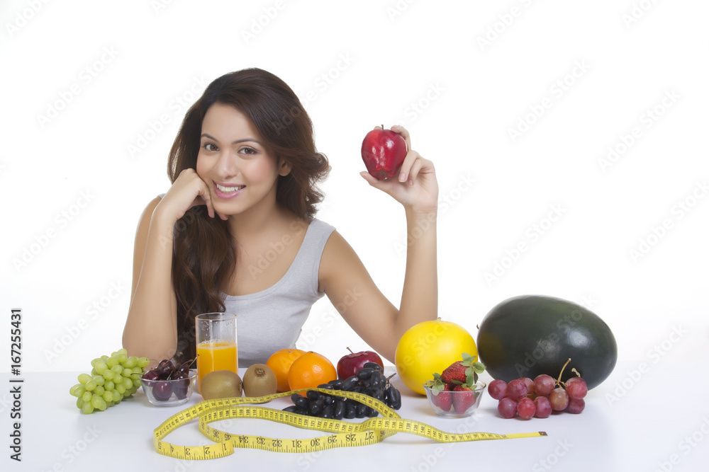 Portrait of woman with fruits and measuring tape Portrait of woman with fruits and measuring tape