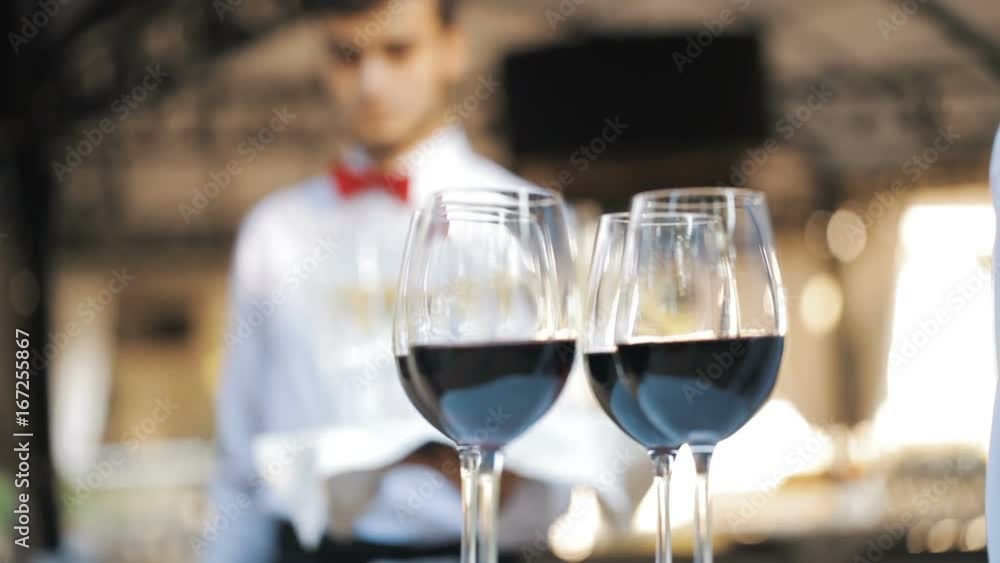 Glasses with wine and champagne on a tray. Meeting with guests Glasses with wine and champagne on a tray. Meeting with guests