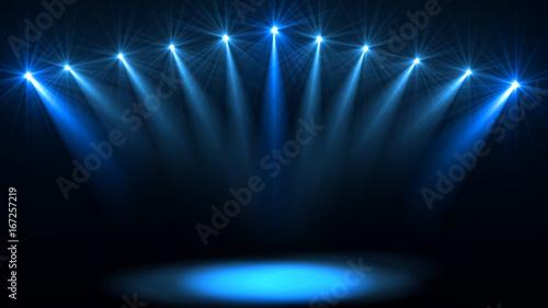 Stage lights. Several projectors in the dark. Purple spotlight strike through the darkness