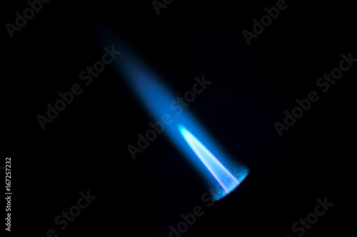 Gas burner flame. Blue fire isolated on black backgroung, close-up photo
