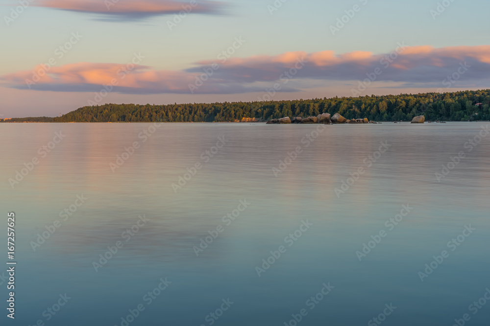 Beautiful Baltic sea landscape with stone breakwater. Tranquil long exposure landscape