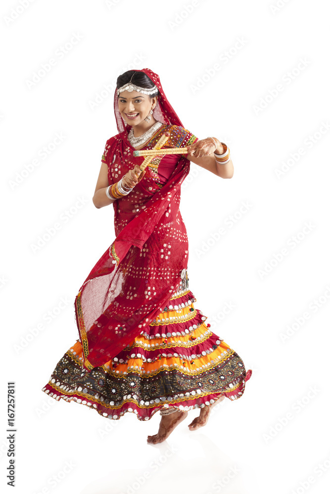 Female dandiya dancer dancing with sticks 
