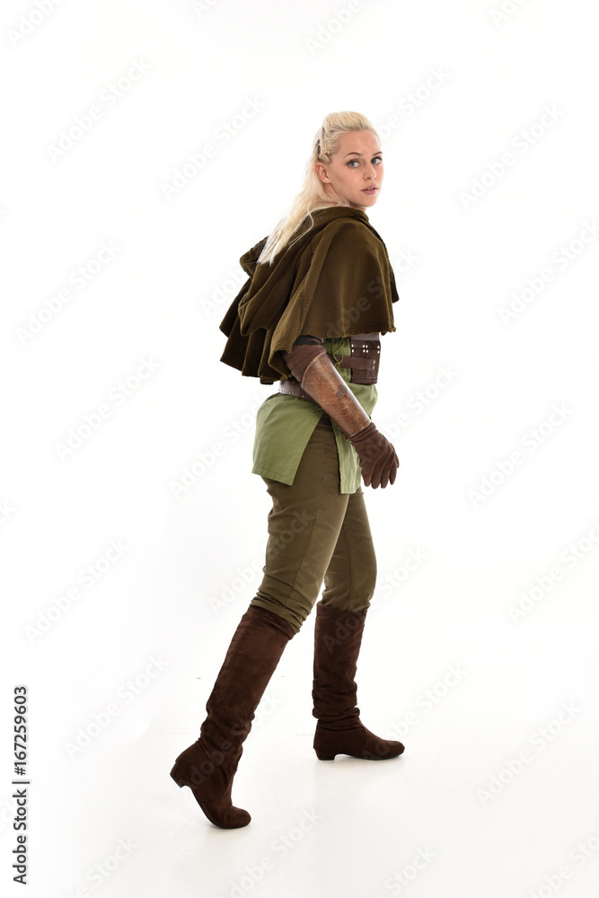 full length portrait of a blonde girl wearing green and brown medieval costume, holding a bow and arrow. isolated on white background. full length portrait of a blonde girl wearing green and brown medieval costume, holding a bow and arrow. isolated on white background.