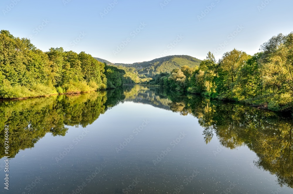 Summer mountain landscape. River against a background of beautiful hills.