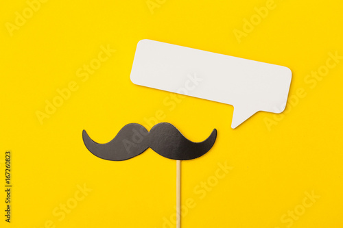 Valokuvatapetti Moustache on a stick with a speech bubble on a bright yellow background