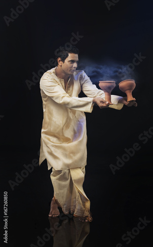 Bengali man doing a Dhunuchi dance 
