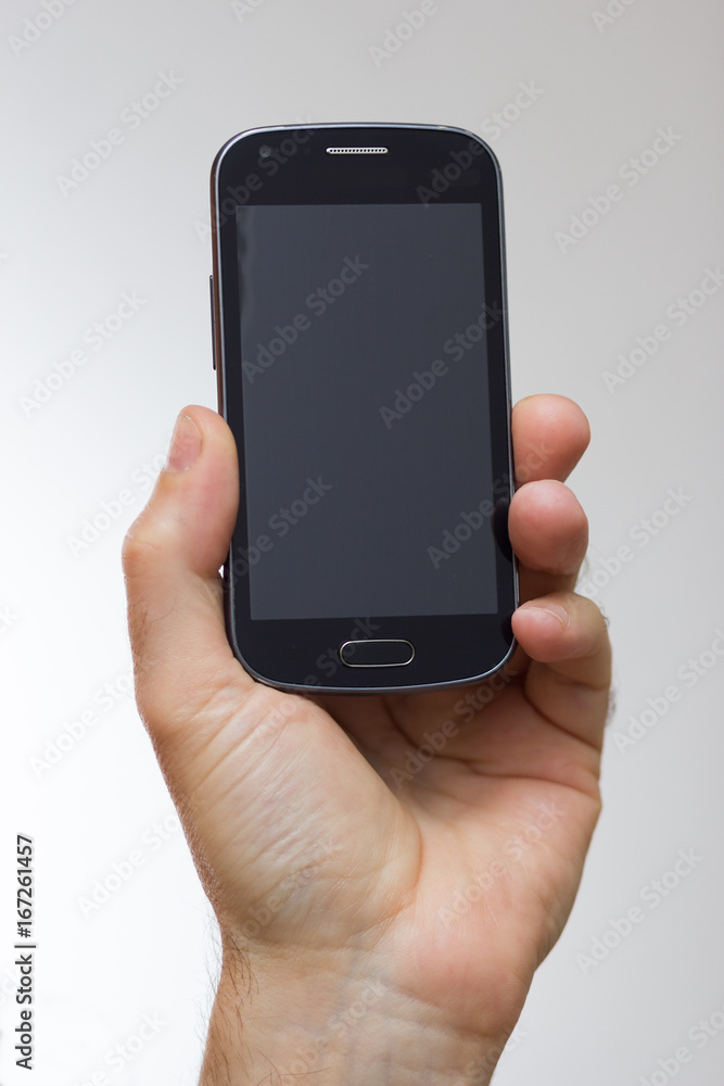 Smartphone in a hand outstretched Smartphone in a hand outstretched