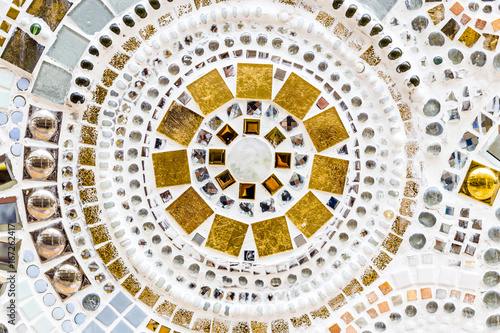 Detail of a beautiful old crumbling abstract ceramic mosaic decoration was destroyed building