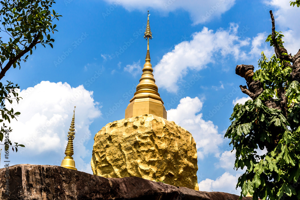 Naklejka premium golden pagoda and golden stone at wat tham pha daen in sakon nakhon thailand.