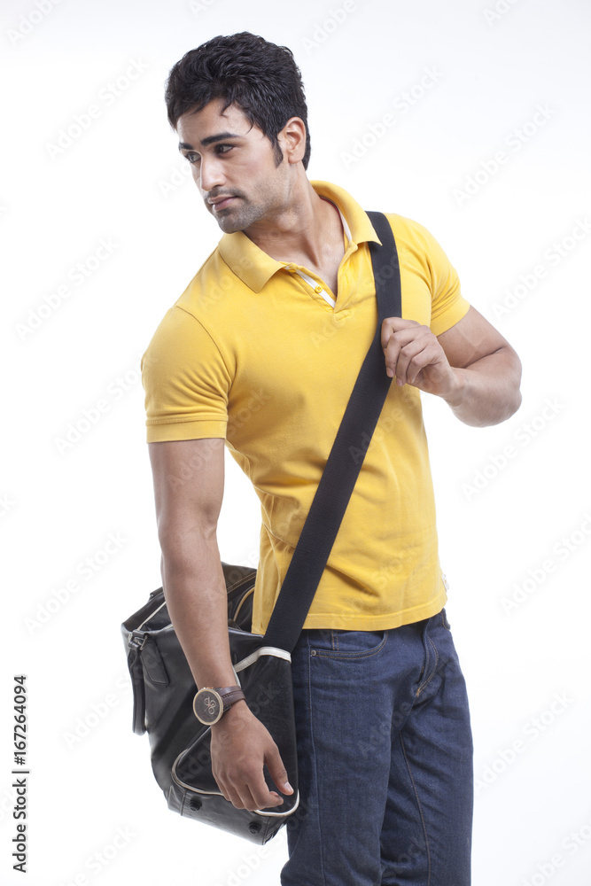 Stylish man with duffle bag looking away Stylish man with duffle bag looking away