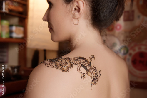 Close-up of temporary tattoo on girl's shoulder