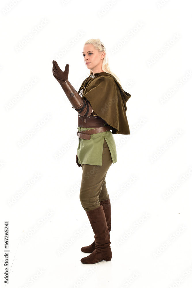 full length portrait of a blonde girl wearing green and brown medieval costume, holding a bow and arrow. isolated on white background. full length portrait of a blonde girl wearing green and brown medieval costume, holding a bow and arrow. isolated on white background.