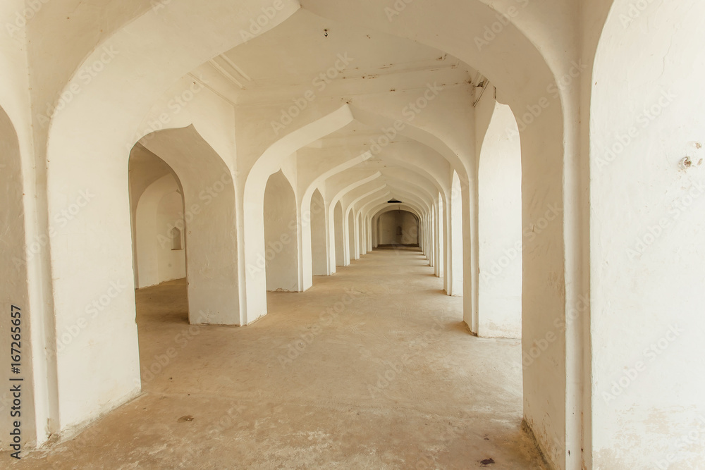White arches in indian house with long corridor inside. Old building in India.