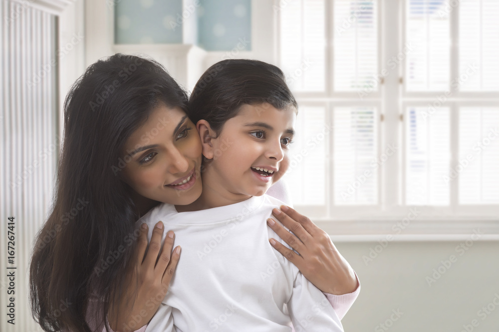 Mother and daughter smiling and looking at mirror Mother and daughter smiling and looking at mirror
