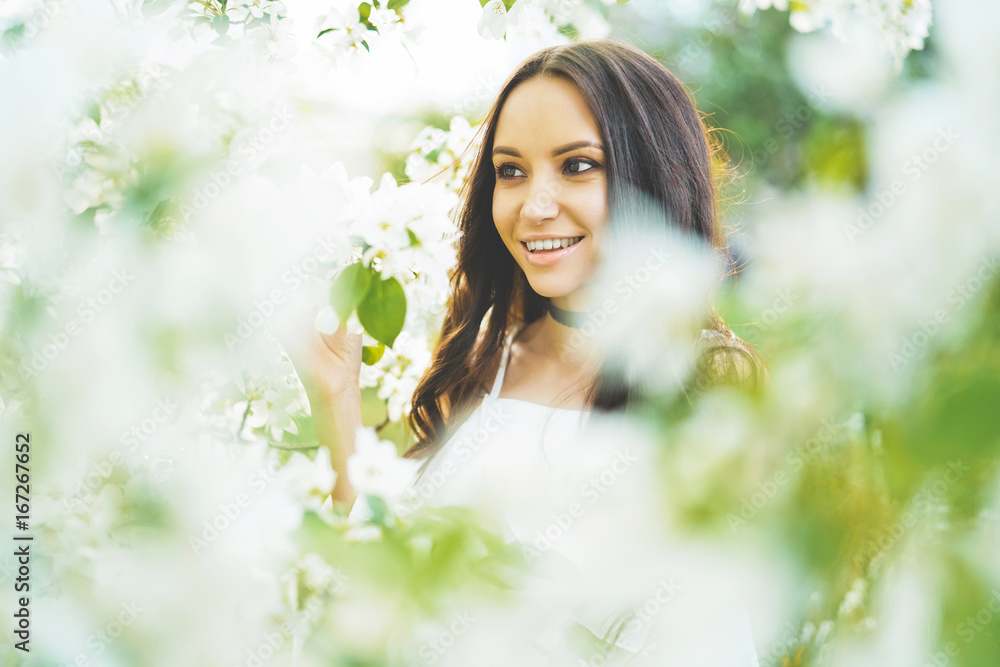 Beautiful young woman surrounded by flowers of apple-tree Beautiful young woman surrounded by flowers of apple-tree