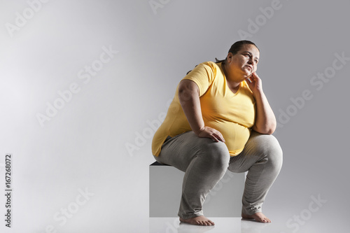 Obese woman thinking photo