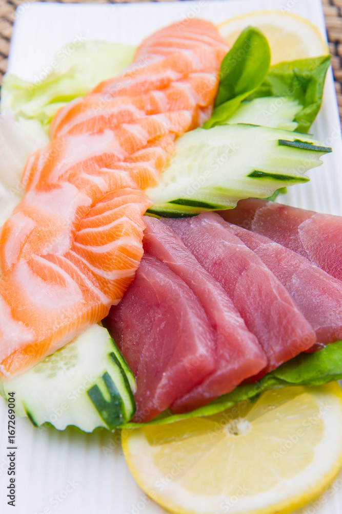 tuna and salmon sashimi on black dish