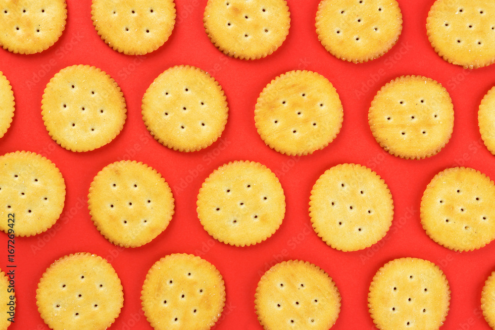 Flat lay crackers pattern on red background Flat lay crackers pattern on red background