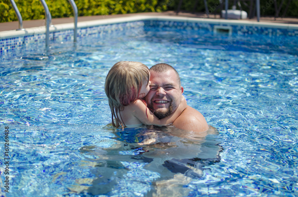 Happy girl with father in the swimming pool. Summer day. Family  vocation