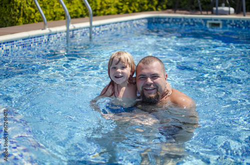 Happy girl with father in the swimming pool. Summer day. Family  vocation © Veronika