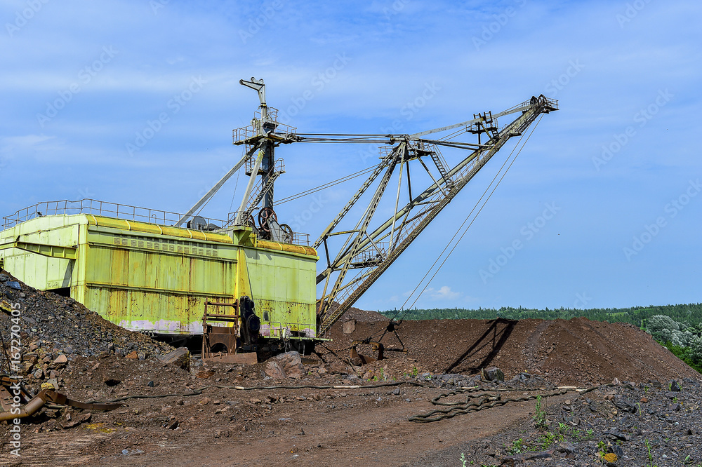 Excavator machine at excavation earthmoving work in quarry Excavator machine at excavation earthmoving work in quarry