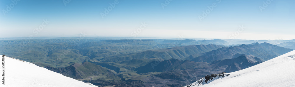Panorama View of the summer northern caucasus from the snow-capped summit of Elbrus