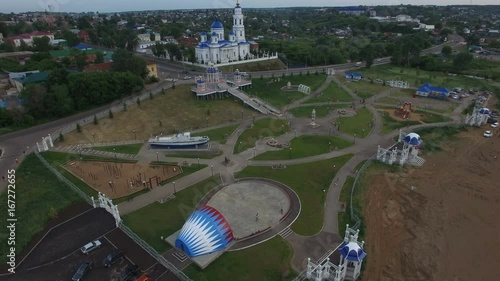 Flight over Park at Church with Stage and People Ride Bikes photo