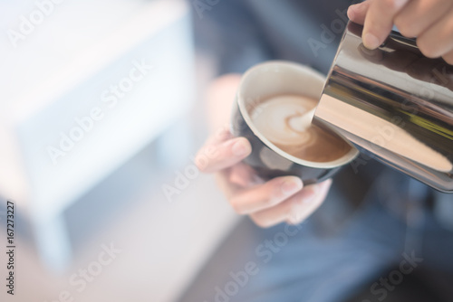 coffee latte art in coffee shop vintage color tone blur