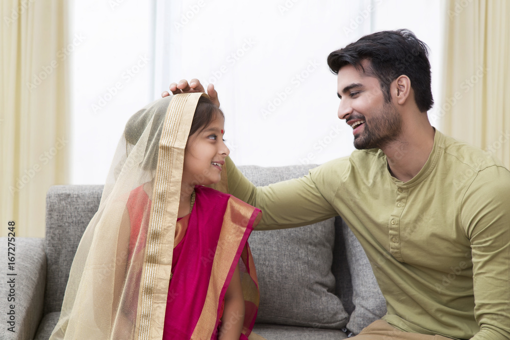 Father looking at her little daughter in bride costume Father looking at her little daughter in bride costume