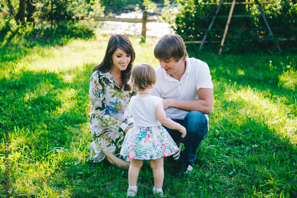 Fototapeta premium parents play with their daughter