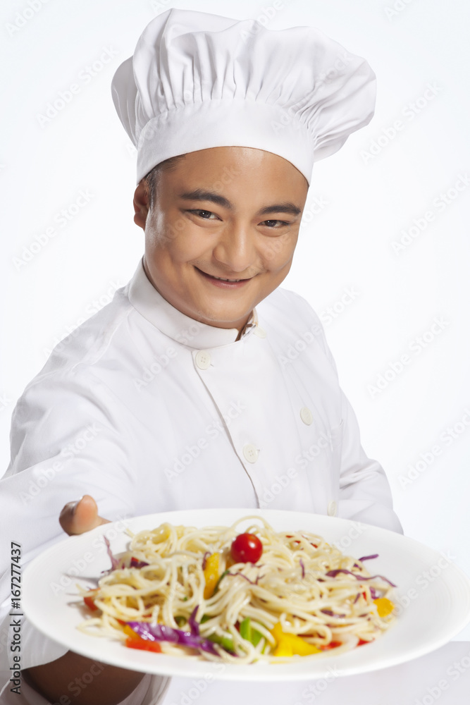 Portrait of chef with plate of noodles Portrait of chef with plate of noodles